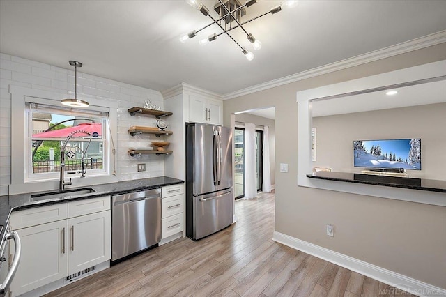 37738 Maplehill St, Harrison Twp, MI 48045 - kitchen featuring appliances with stainless steel finishes, light wood-style floors, plenty of natural light, a chandelier, and ornamental molding