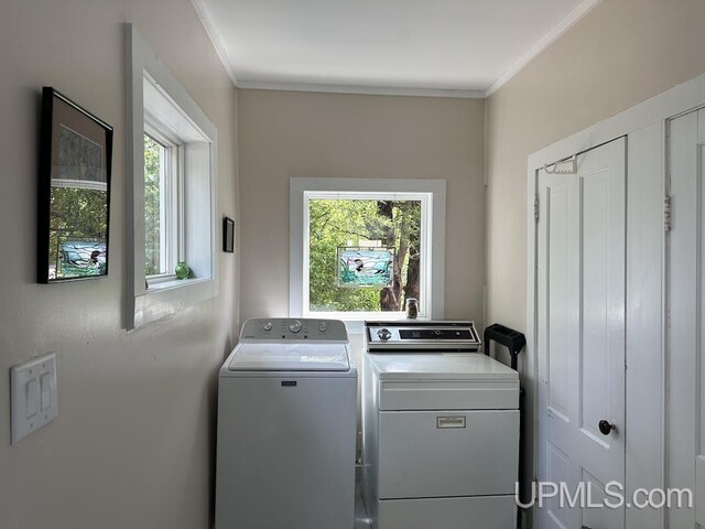 21988 E Everett Ave, Grand Marais, MI 49839 - laundry area featuring washer and clothes dryer, healthy amount of natural light, and ornamental molding