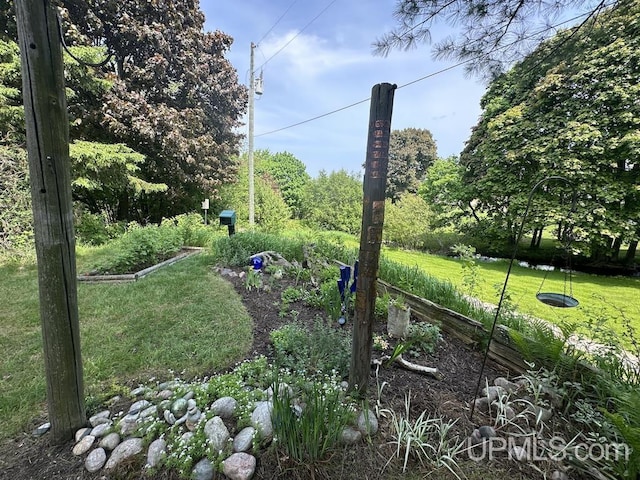 21988 E Everett Ave, Grand Marais, MI 49839 - view of green lawn featuring a vegetable garden