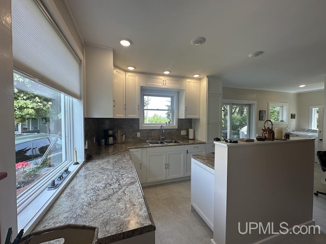 21988 E Everett Ave, Grand Marais, MI 49839 - kitchen with tasteful backsplash, white cabinets, a kitchen island, recessed lighting, and ornamental molding