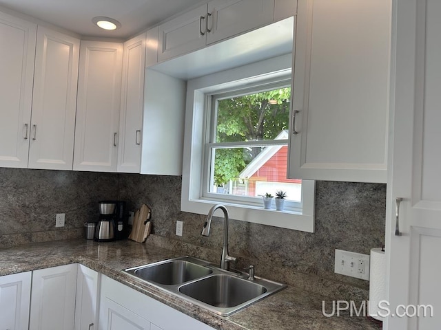 21988 E Everett Ave, Grand Marais, MI 49839 - kitchen with white cabinets, decorative backsplash, and dark countertops