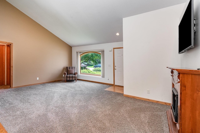 810 Natures Ridge Ln, Bay City, MI 48708 - unfurnished living room with carpet, a fireplace, lofted ceiling, and recessed lighting