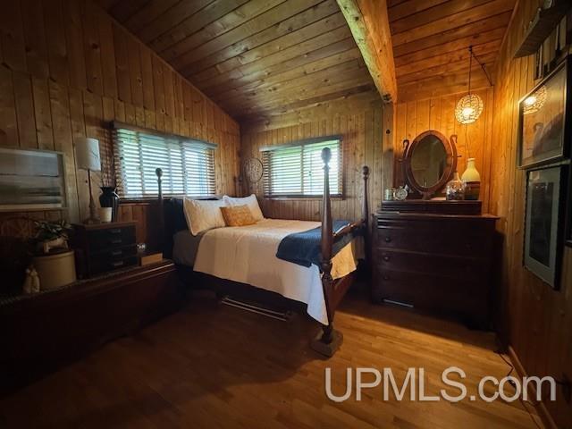 5847 County 513 T Rd, Rapid River, MI 49878 - bedroom featuring wood finished floors, wooden walls, vaulted ceiling, and wood ceiling