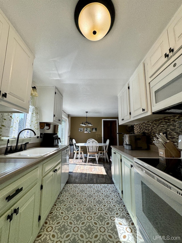 4828 I Rd, Bark River, MI 49807 - kitchen with white appliances, a textured ceiling, backsplash, and white cabinets