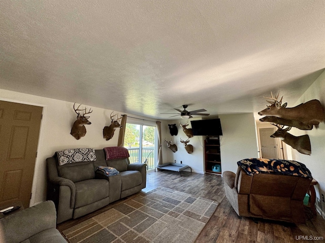 4828 I Rd, Bark River, MI 49807 - living room with a textured ceiling, dark wood-style flooring, and a ceiling fan