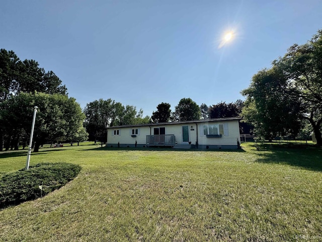 4828 I Rd, Bark River, MI 49807 - back of house featuring crawl space, a lawn, and a deck