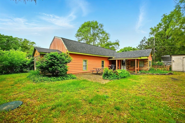 9970 Sedlock Ave, White Lake, MI 48386 - back of house featuring a lawn and a patio