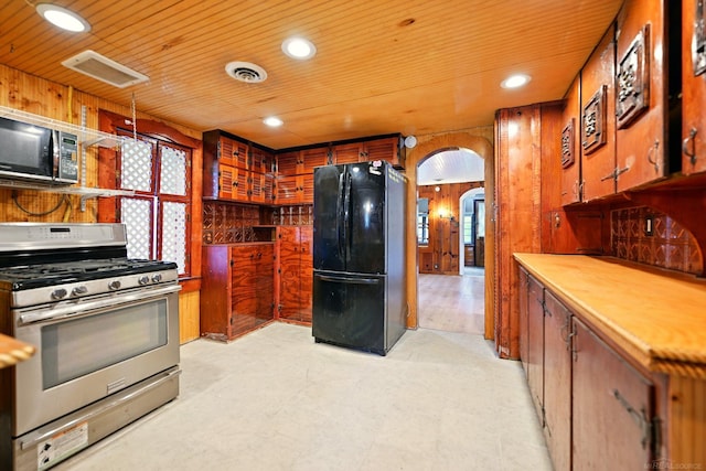 9970 Sedlock Ave, White Lake, MI 48386 - kitchen featuring black appliances, wooden walls, arched walkways, wood ceiling, and recessed lighting