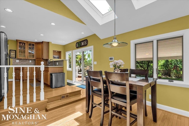 1076 Kelley St, Troy, MI 48083 - dining space with light wood-style floors, a skylight, and recessed lighting