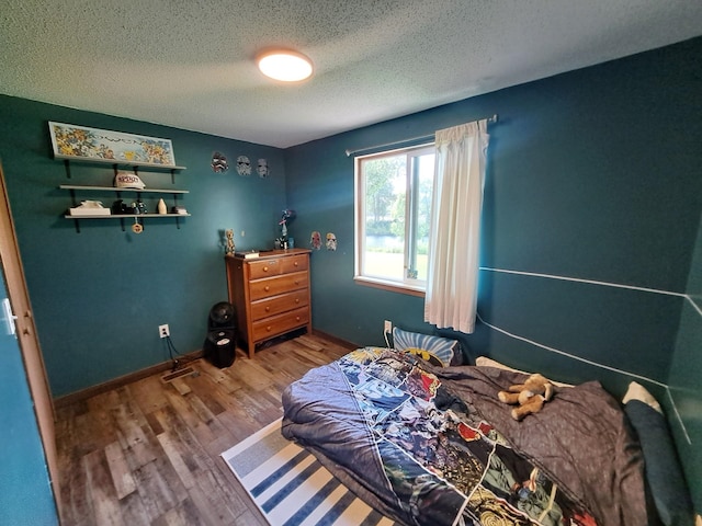 250 Witbeck Dr, Clare, MI 48617 - bedroom with a textured ceiling and wood finished floors