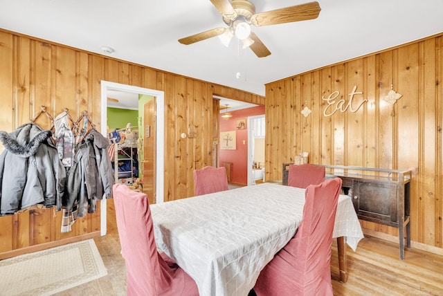 8941 Lakeshore Rd, Lexington, MI 48450 - dining area featuring wood walls, a ceiling fan, and wood finished floors