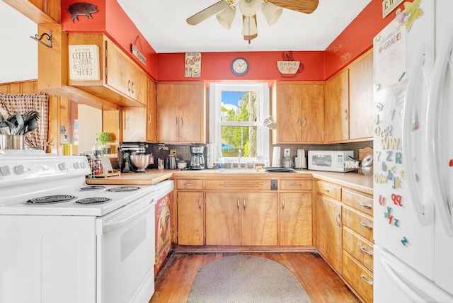 8941 Lakeshore Rd, Lexington, MI 48450 - kitchen with white appliances, light countertops, backsplash, and light wood-style flooring
