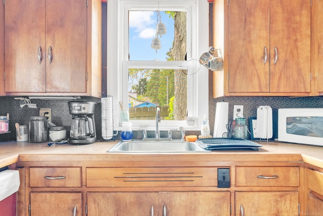 8941 Lakeshore Rd, Lexington, MI 48450 - kitchen with light countertops, plenty of natural light, and dishwashing machine