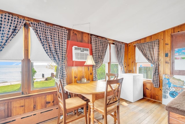 8941 Lakeshore Rd, Lexington, MI 48450 - dining area featuring wooden walls, light wood-type flooring, and an AC wall unit