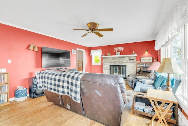8941 Lakeshore Rd, Lexington, MI 48450 - living room with ceiling fan, wood finished floors, a fireplace, and crown molding