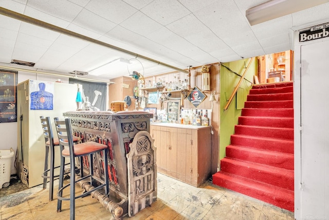 8941 Lakeshore Rd, Lexington, MI 48450 - indoor dry bar with freestanding refrigerator and stairway