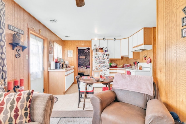8941 Lakeshore Rd, Lexington, MI 48450 - kitchen featuring range, range hood, white cabinets, light countertops, and freestanding refrigerator