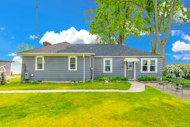 8941 Lakeshore Rd, Lexington, MI 48450 - ranch-style home with a front yard, a chimney, a patio, and roof with shingles