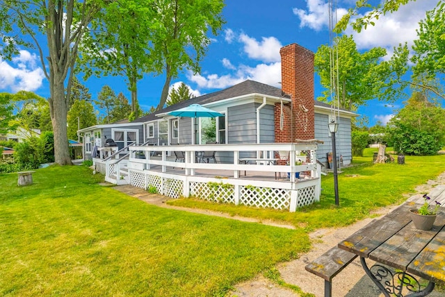 8941 Lakeshore Rd, Lexington, MI 48450 - back of property featuring a yard, a deck, and a chimney