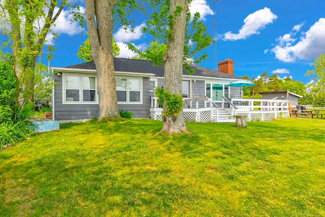 8941 Lakeshore Rd, Lexington, MI 48450 - back of house featuring a wooden deck, a yard, and a chimney