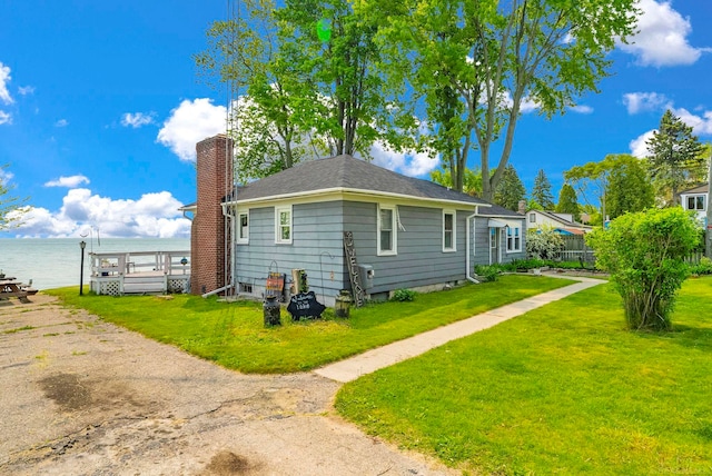 8941 Lakeshore Rd, Lexington, MI 48450 - view of property exterior featuring a yard, a chimney, and a water view