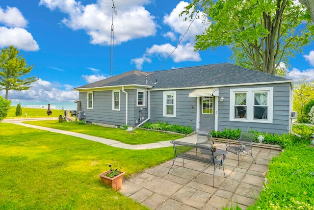 8941 Lakeshore Rd, Lexington, MI 48450 - back of property with a lawn, roof with shingles, and a water view