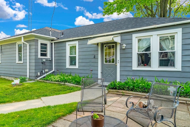 8941 Lakeshore Rd, Lexington, MI 48450 - view of front facade with a patio area, a front lawn, and roof with shingles