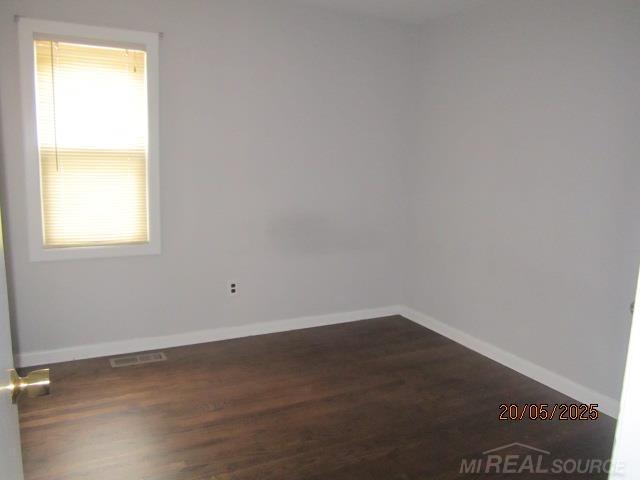 22636 Downing St, Saint Clair Shores, MI 48080 - empty room featuring baseboards and dark wood-style flooring