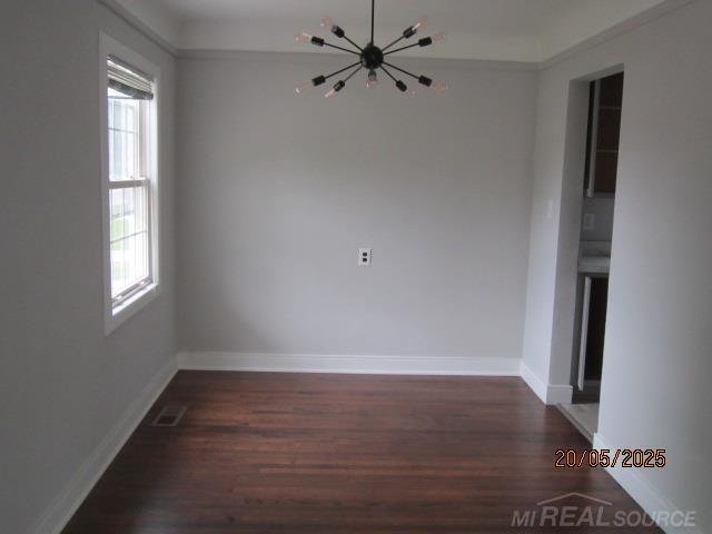 22636 Downing St, Saint Clair Shores, MI 48080 - unfurnished dining area featuring wood finished floors and a chandelier