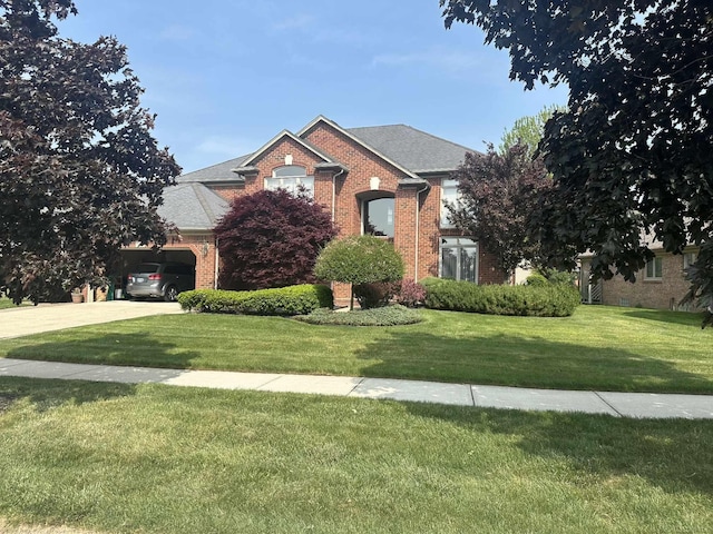 48274 Prestwyck Rd, Macomb, MI 48044 - traditional-style home featuring brick siding, driveway, and a front lawn