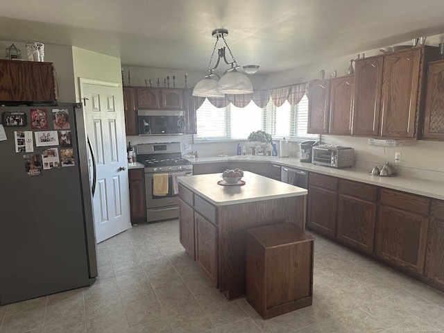 48274 Prestwyck Rd, Macomb, MI 48044 - kitchen featuring appliances with stainless steel finishes, light countertops, a center island, decorative light fixtures, and light tile patterned flooring