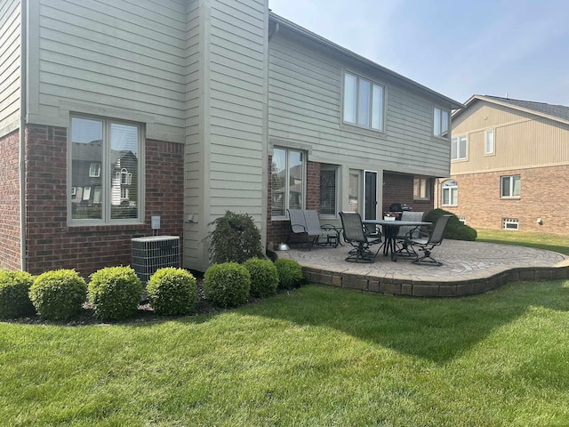 48274 Prestwyck Rd, Macomb, MI 48044 - back of house featuring brick siding, a patio area, and a yard