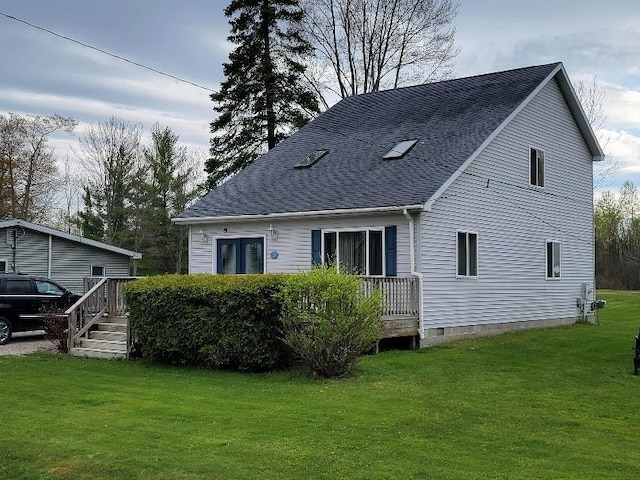 4161 Pine St, Gladwin, MI 48624 - back of house featuring a lawn and roof with shingles