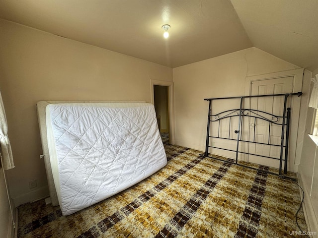 406 S 12th St, Escanaba, MI 49829 - unfurnished bedroom featuring lofted ceiling
