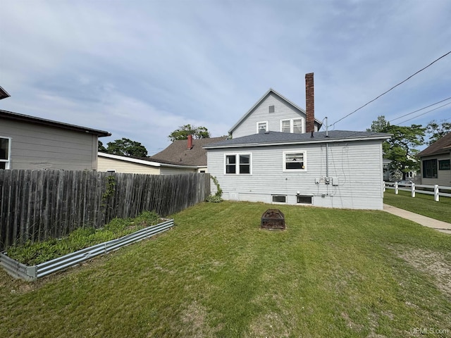 406 S 12th St, Escanaba, MI 49829 - rear view of property with an outdoor fire pit and a chimney
