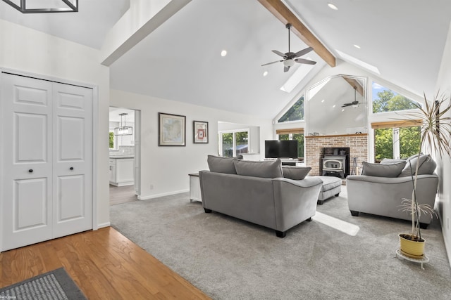 6767 Puttygut Rd, East China, MI 48054 - living room featuring a ceiling fan, beam ceiling, high vaulted ceiling, a skylight, and wood finished floors