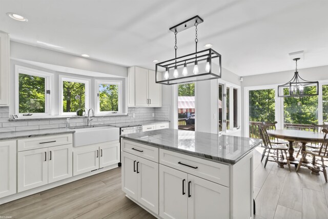 6767 Puttygut Rd, East China, MI 48054 - kitchen featuring recessed lighting, decorative backsplash, plenty of natural light, light stone counters, and white cabinets