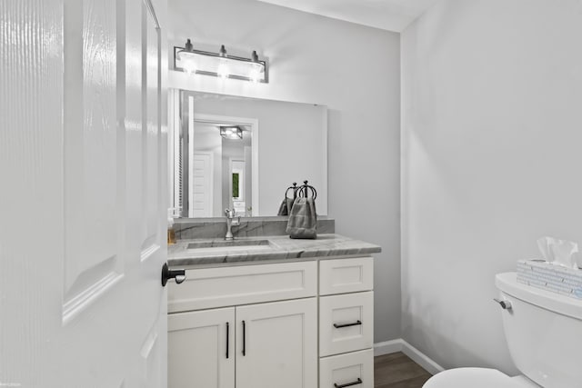 6767 Puttygut Rd, East China, MI 48054 - half bathroom featuring vanity and wood finished floors