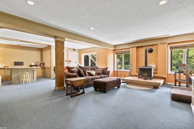 6767 Puttygut Rd, East China, MI 48054 - living room with a wood stove, plenty of natural light, a textured ceiling, recessed lighting, and an office area