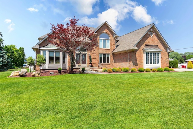 31595 N River Rd, Harrison Twp, MI 48045 - view of front of home with brick siding and a front lawn