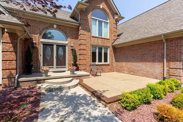 31595 N River Rd, Harrison Twp, MI 48045 - entrance to property with roof with shingles and brick siding