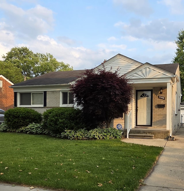 23018 Englehardt Cmn, Saint Clair Shores, MI 48080 - view of front of house featuring a front yard and brick siding