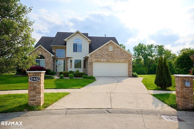 21832 Preserve Ct, Macomb Twp, MI 48042 - traditional home with brick siding, a front yard, driveway, and a garage