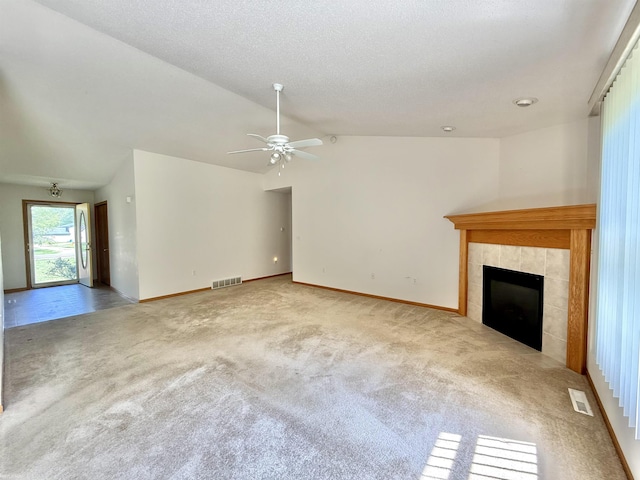 1248 S Hemlock Rd, Hemlock, MI 48626 - unfurnished living room with carpet, lofted ceiling, a ceiling fan, and a tile fireplace