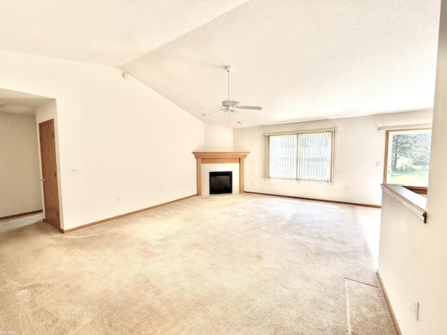 1248 S Hemlock Rd, Hemlock, MI 48626 - unfurnished living room featuring ceiling fan, a glass covered fireplace, light carpet, lofted ceiling, and a textured ceiling
