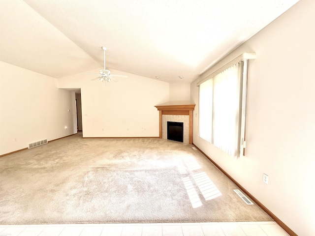 1248 S Hemlock Rd, Hemlock, MI 48626 - unfurnished living room featuring lofted ceiling, a ceiling fan, a tile fireplace, and carpet floors