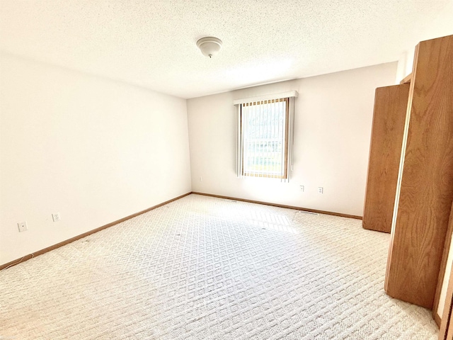 1248 S Hemlock Rd, Hemlock, MI 48626 - empty room with light colored carpet and a textured ceiling