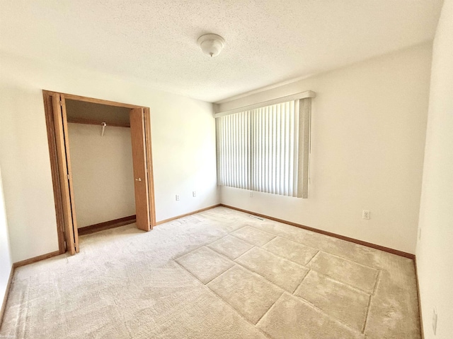 1248 S Hemlock Rd, Hemlock, MI 48626 - unfurnished bedroom with a textured ceiling, a closet, and carpet floors