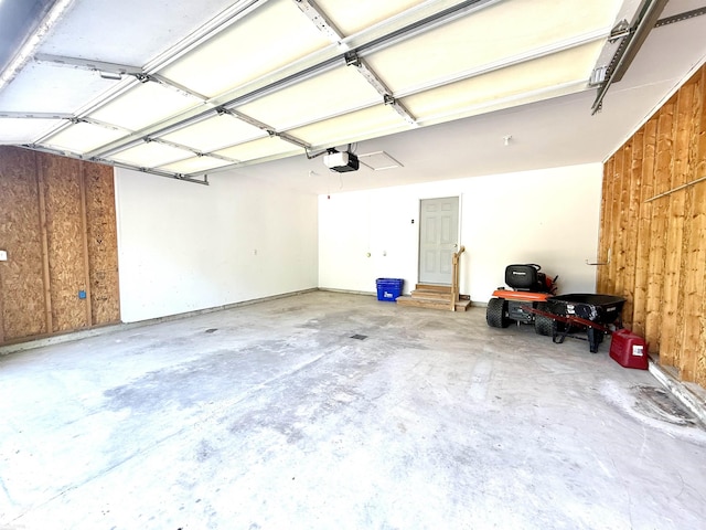 1248 S Hemlock Rd, Hemlock, MI 48626 - garage featuring a garage door opener and wood walls