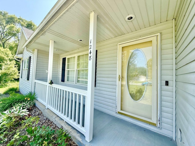 1248 S Hemlock Rd, Hemlock, MI 48626 - view of exterior entry with a porch and a surveillance system